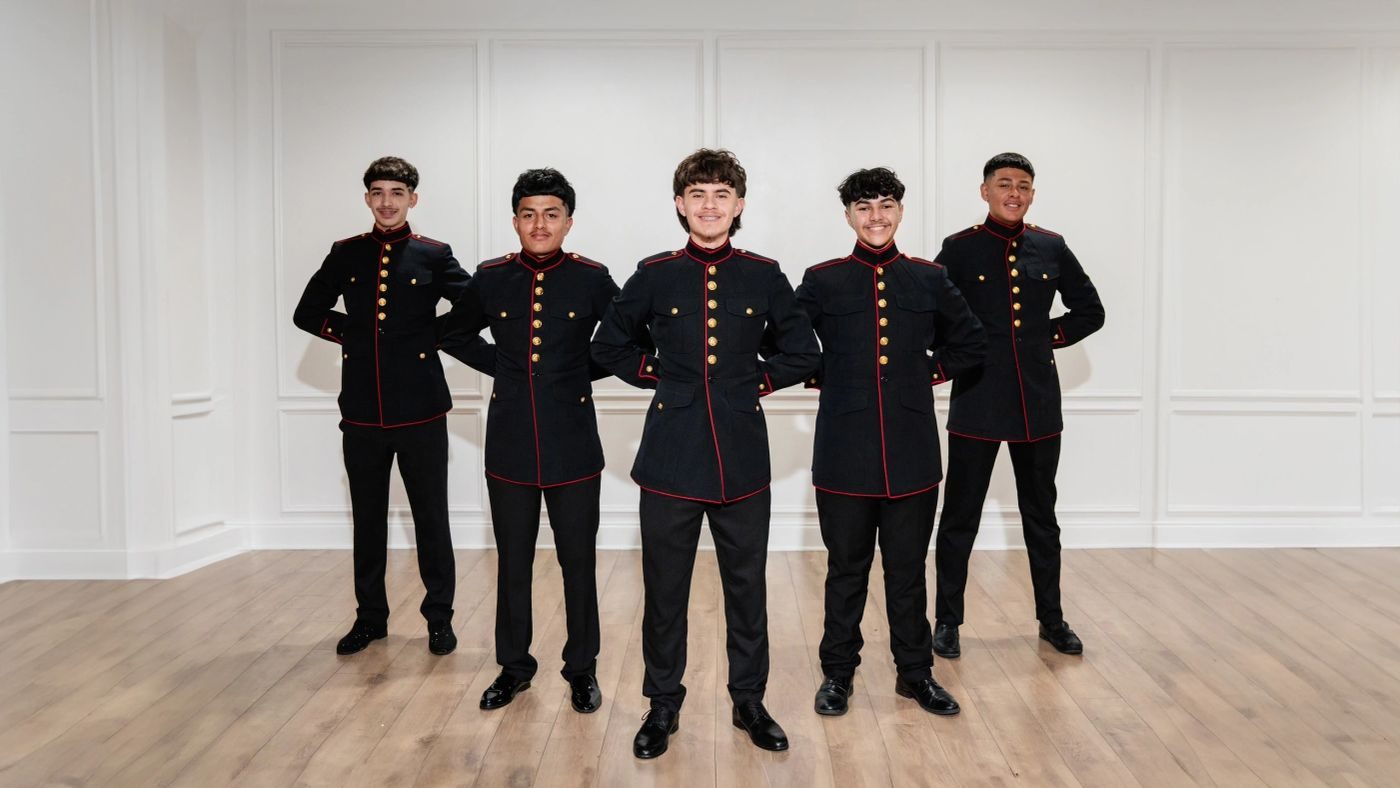 Cadets lined up in black formalwear before the entrance