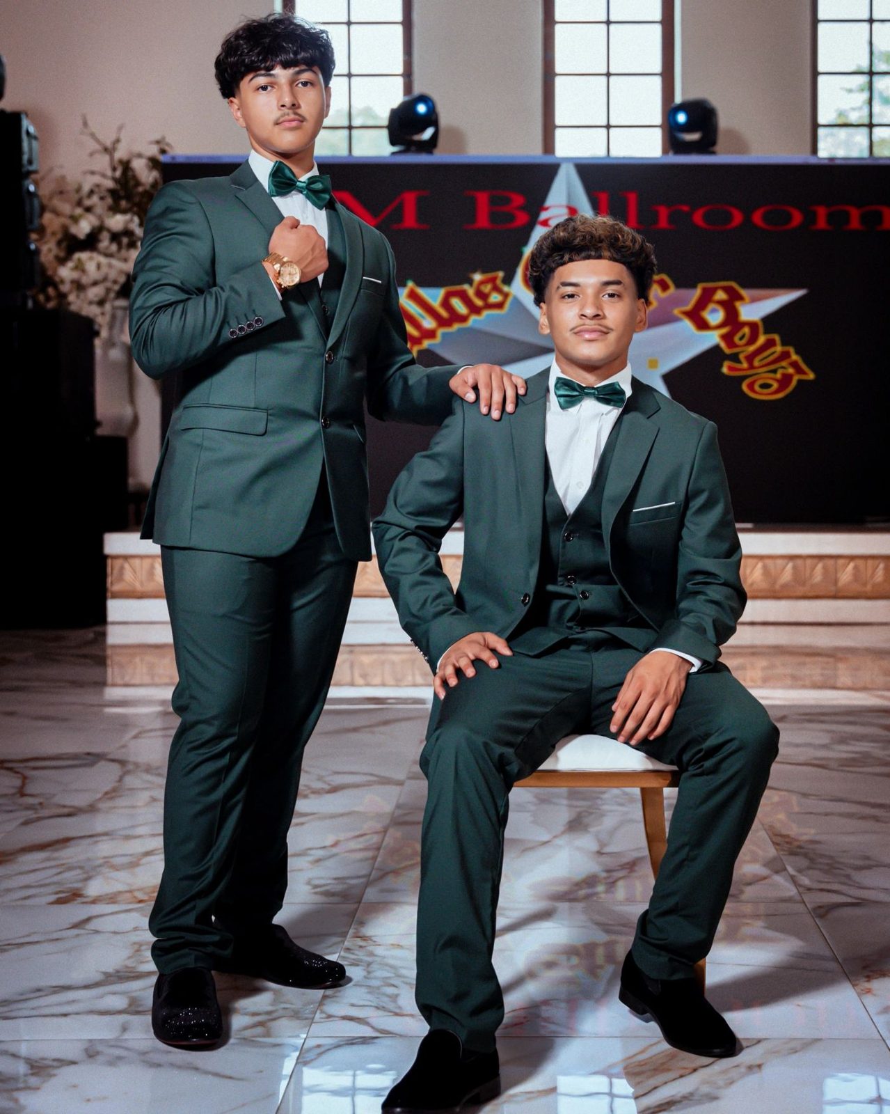 Emerald green rented suits worn by two chambelanes